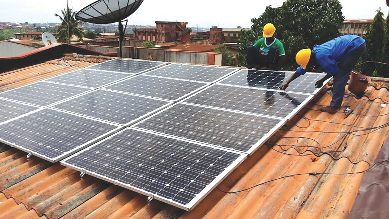 Solar installers working on a rooftop solar in Nigeria