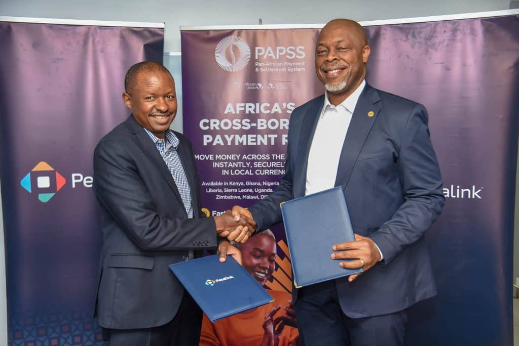Pesalink CEO, Gituku Kirika (left) and PAPSS CEO, Mike Ogbalu III shaking hands